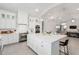 Bright kitchen featuring white cabinets, a large island, and stainless steel appliances at 42223 N Golden Trl, San Tan Valley, AZ 85140