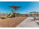 Community playground with shaded play structure and slides at 42223 N Golden Trl, San Tan Valley, AZ 85140