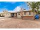 Brick Ranch home with a spacious front yard and mature trees at 4405 W Clarendon Ave, Phoenix, AZ 85031