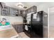 Galley kitchen with dark cabinets and appliances at 4405 W Clarendon Ave, Phoenix, AZ 85031