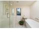 Modern bathroom with a soaking tub, glass shower, and hexagon tile at 4432 E Camelback Rd # 120, Phoenix, AZ 85018