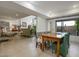 Open dining room with farmhouse table and green chairs, offering views to the living room at 4432 E Camelback Rd # 120, Phoenix, AZ 85018