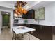 Modern kitchen with marble island and copper pot rack at 4432 E Camelback Rd # 120, Phoenix, AZ 85018