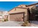 Two-story house with a brown garage door and landscaping at 4777 S Fulton Ranch Blvd # 1027, Chandler, AZ 85248