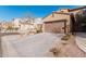 Tan house with a brown garage door and driveway at 4777 S Fulton Ranch Blvd # 1027, Chandler, AZ 85248