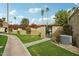 Landscaped yard with vibrant bougainvillea and a secure gate leading to the property at 4800 N 68Th N St # 228, Scottsdale, AZ 85251