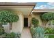 Inviting front entrance with well-maintained landscaping featuring mature trees and desert plants at 4800 N 68Th N St # 228, Scottsdale, AZ 85251