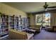 Cozy seating area with bookshelves and a large window overlooking the beautiful landscaping at 4800 N 68Th N St # 228, Scottsdale, AZ 85251