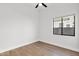 Bright bedroom featuring wood-look floors and a window at 4835 E Daley Ln, Phoenix, AZ 85054