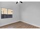 Bright bedroom with wood-look floors and a window at 4835 E Daley Ln, Phoenix, AZ 85054