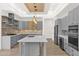 Gray kitchen with an island and wood-beamed ceiling at 4835 E Daley Ln, Phoenix, AZ 85054