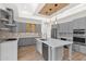 Gray kitchen with an island and wood-beamed ceiling at 4835 E Daley Ln, Phoenix, AZ 85054