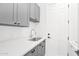 Laundry room with gray cabinets and quartz countertop at 4835 E Daley Ln, Phoenix, AZ 85054