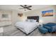 King bed, blue accent chair, and ceiling fan in bedroom at 4850 E Desert Cove Ave # 132, Scottsdale, AZ 85254