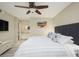 King-size bed, ceiling fan, and gray headboard in the bedroom at 4850 E Desert Cove Ave # 132, Scottsdale, AZ 85254