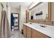 Double vanity bathroom with a tiled backsplash and mirrored medicine cabinet at 7337 W Claremont St, Glendale, AZ 85303