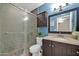 Bathroom with dark vanity, shower, and blue walls at 7337 W Claremont St, Glendale, AZ 85303