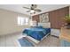 Bedroom with wood accent wall, ceiling fan and white dresser at 7337 W Claremont St, Glendale, AZ 85303