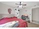 Bedroom with a red comforter, a gaming setup, and shelving at 7337 W Claremont St, Glendale, AZ 85303