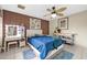 Bedroom with wood accent wall, ceiling fan and white dresser at 7337 W Claremont St, Glendale, AZ 85303