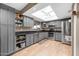 Modern kitchen with gray cabinets, stainless steel appliances, and light wood floors at 7337 W Claremont St, Glendale, AZ 85303