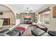 Living room with stone wall, TV, and ample seating at 7337 W Claremont St, Glendale, AZ 85303