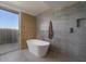 Modern bathroom with a freestanding tub and gray tile at 7724 E Long Rifle Rd, Carefree, AZ 85377