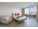 Bright bedroom with wooden bed frame and sliding glass door leading to scenic views at 7724 E Long Rifle Rd, Carefree, AZ 85377