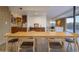 Dining area with long wooden table and modern chairs at 7724 E Long Rifle Rd, Carefree, AZ 85377