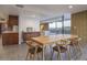 Modern dining area with a long wooden table and chairs at 7724 E Long Rifle Rd, Carefree, AZ 85377