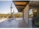 Relaxing patio with mid-century modern furniture and desert views at 7724 E Long Rifle Rd, Carefree, AZ 85377