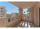 Balcony view with a railing overlooking a street with palm trees, other apartment buildings, and blue skies at 7930 E Camelback Rd # 509, Scottsdale, AZ 85251