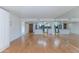 Bright living room with hardwood floors and mirrored wall opposite the kitchen area at 7930 E Camelback Rd # 509, Scottsdale, AZ 85251