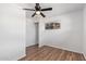 Cozy bedroom with hardwood floors, a ceiling fan, and a spacious closet at 8215 E 2Nd Ave, Mesa, AZ 85208