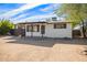 Cute Ranch style home with a large front yard and a nice front porch at 8215 E 2Nd Ave, Mesa, AZ 85208