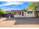 Charming single story home with a well-manicured front yard and spacious driveway at 8215 E 2Nd Ave, Mesa, AZ 85208