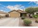 Tan house with garage and landscaping at 851 E Bradstock Way, San Tan Valley, AZ 85140