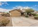 Tan house with garage and landscaping at 851 E Bradstock Way, San Tan Valley, AZ 85140