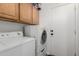 Bright laundry room with washer, dryer, and cabinets at 851 E Bradstock Way, San Tan Valley, AZ 85140