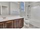 Bathroom with a bathtub, shower, and dark brown vanity at 8539 W Lamar Rd, Glendale, AZ 85305