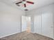 Bright bedroom featuring ceiling fan and double door closet at 8539 W Lamar Rd, Glendale, AZ 85305