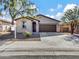 Single-story house with a two-car garage and drought-tolerant landscaping at 8539 W Lamar Rd, Glendale, AZ 85305