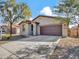 Tan, one-story house with a brown garage door at 8539 W Lamar Rd, Glendale, AZ 85305