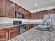 Granite countertop kitchen with stainless steel sink and faucet at 8539 W Lamar Rd, Glendale, AZ 85305