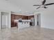 Kitchen with island, granite countertops, and dark wood cabinets at 8539 W Lamar Rd, Glendale, AZ 85305