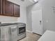 Laundry room with storage cabinets and exterior access at 8539 W Lamar Rd, Glendale, AZ 85305