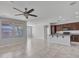 Open living room and kitchen with tile floors and ceiling fan at 8539 W Lamar Rd, Glendale, AZ 85305