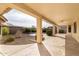 Extended covered patio, offering ample shade and views of the backyard at 9007 E Emerald Dr, Sun Lakes, AZ 85248