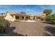 Large backyard with gravel, a patio, and a home with solar panels at 9007 E Emerald Dr, Sun Lakes, AZ 85248