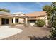 Landscaped backyard with covered patio and storage shed at 9007 E Emerald Dr, Sun Lakes, AZ 85248